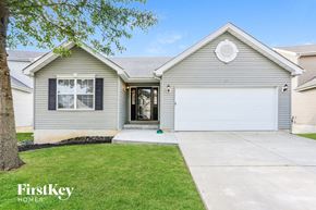 Wentzville house for rent - a white and gray house with a driveway and grass