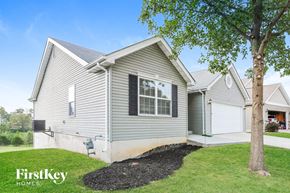 Wentzville house for rent - the exterior of a house with a yard and a tree