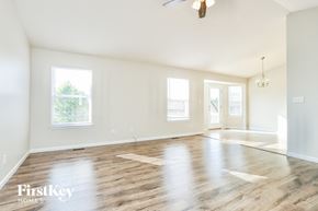 Wentzville house for rent - an empty living room with white walls and wood floors