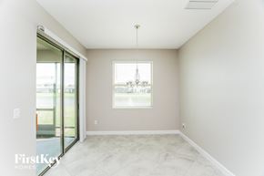 Ruskin house for rent - A room with a sliding glass door and a window with a chandelier hanging from the ceiling.
