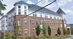 Washington apartment for rent - a large brick building with a power line in front of it