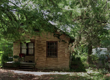 Houston apartment for rent - a small brick house with trees in front of it