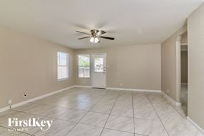 San Antonio house for rent - a spacious living room with tile flooring and a ceiling fan