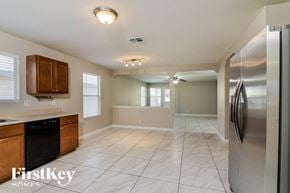 San Antonio house for rent - an empty kitchen with stainless steel appliances and tile flooring