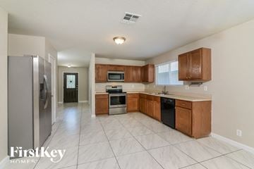 San Antonio house for rent - a kitchen with wooden cabinets and stainless steel appliances