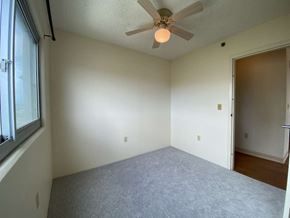 Waipahu apartment for rent - an empty living room with a ceiling fan and a window
