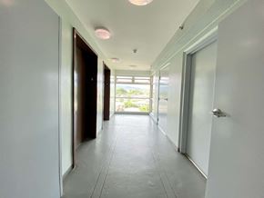 Waipahu apartment for rent - a long hallway with doors and a window at the end