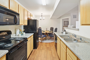 Apache Junction apartment for rent - full kitchen with black appliances and a dining room with a table