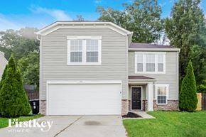 Concord house for rent - a beige house with a white garage door