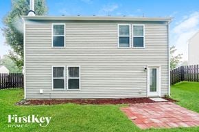 Concord house for rent - the front of a white house with a yard and grass
