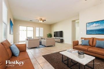 Buckeye house for rent - A living room with a brown couch and a white coffee table.