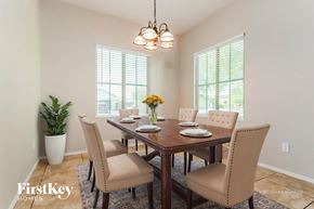 Buckeye house for rent - A dining room with a wooden table and chairs.