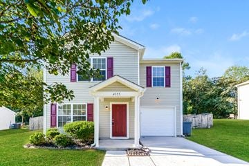 Winston Salem house for rent - a white house with purple shutters and a red door
