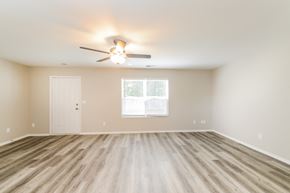Winston Salem house for rent - an empty living room with a ceiling fan and a window