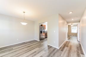 Winston Salem house for rent - the living room and kitchen of a new home with a hardwood floor