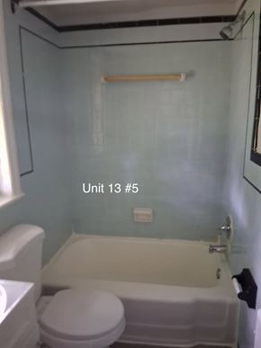 Trenton apartment for rent - A bathroom with a toilet, sink, and bathtub.