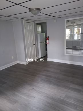 Trenton apartment for rent - A room with a door and a fire extinguisher.