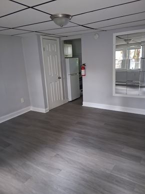 Trenton apartment for rent - A room with a grey floor and a white door.