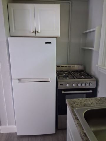 Trenton apartment for rent - A white fridge and stove in a kitchen.