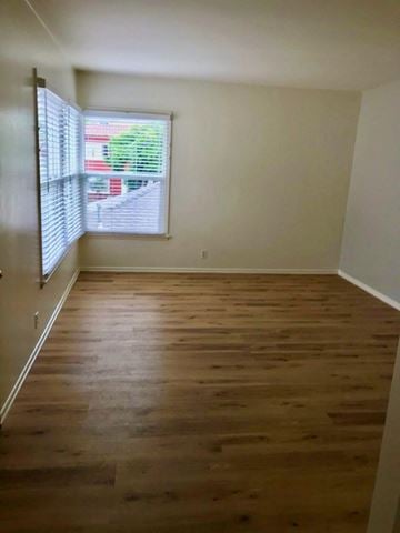 Wilson house for rent - an empty room with wooden floors and a window