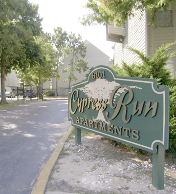 New Orleans apartment for rent - a sign for the chrysalis run apartments on the side of a street