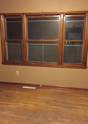 Windsor house for rent - A window with a wooden frame and three panes of glass.
