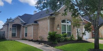 Sugar Land house for rent - a brick house with a sidewalk and a tree