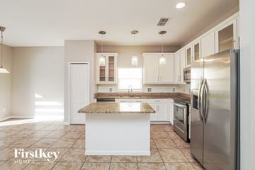 Orlando house for rent - A kitchen with a granite countertop and stainless steel appliances.