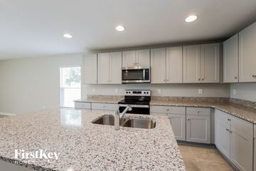 Davenport house for rent - a white kitchen with granite counter tops and white cabinets
