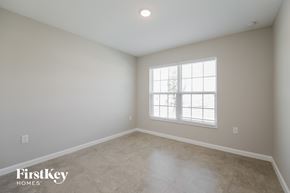 Davenport house for rent - the spacious living room with limestone floors and a window