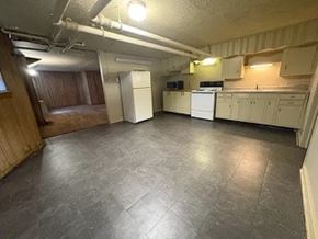 Fremont apartment for rent - A kitchen with white appliances and wooden cabinets.