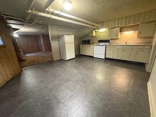 Fremont apartment for rent - A kitchen with white appliances and wooden cabinets.