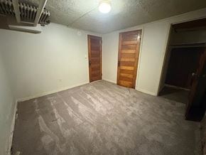 Fremont apartment for rent - A room with a wooden door and a ceiling fan.