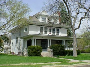 Fremont apartment for rent - A white house with a grey roof and a tree in front.