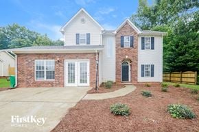King house for rent - A two-story house with a brick facade and a white roof.