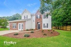 King house for rent - A house with a brick chimney and a white exterior is for sale by FirstKey Homes.