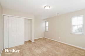 Gastonia house for rent - a bedroom with a white door and a carpeted floor