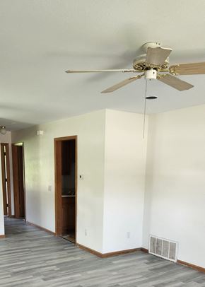 Clinton apartment for rent - A room with a ceiling fan and a door.