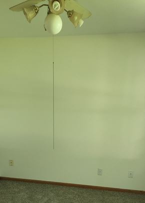 Clinton apartment for rent - A white ceiling fan with five blades is hanging from the ceiling.