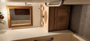 Clinton apartment for rent - A bathroom with a mirror and a wooden door.