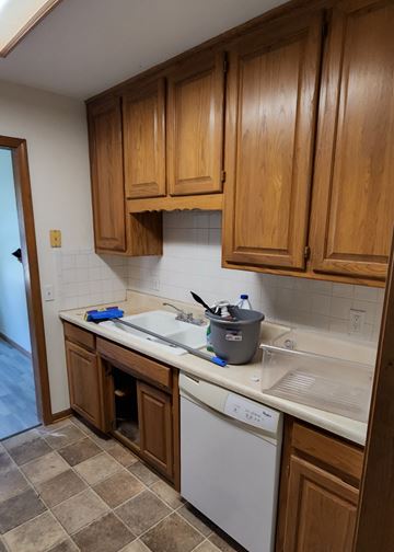 Clinton apartment for rent - A kitchen with wooden cabinets and a white dishwasher.