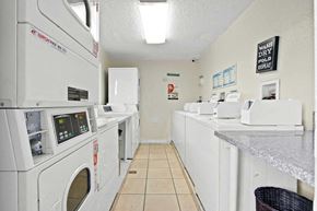 Buena Park apartment for rent - a laundry room filled with washes and dryers