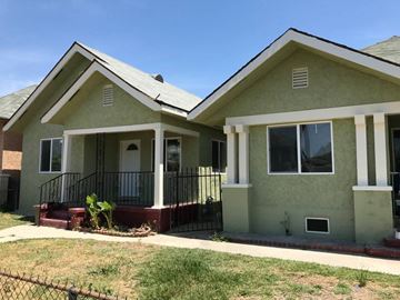 Los Angeles apartment for rent - a green house with a yard and a black fence