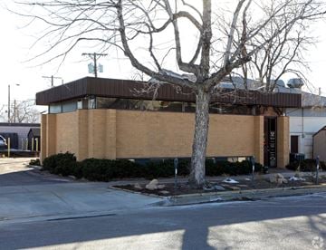 Colorado Springs apartment for rent - A building with a brown facade and a tree in front of it.