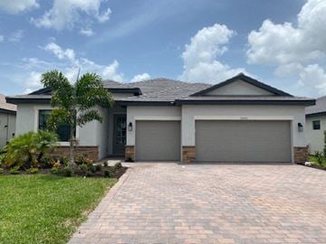 Estero house for rent - A house with a grey roof and two garage doors.