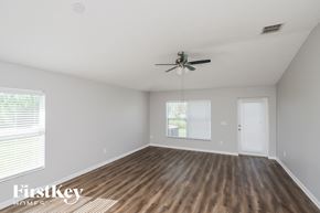 Palm Bay house for rent - the spacious living room with hardwood floors and a ceiling fan