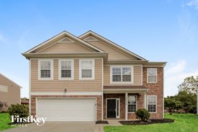 Charlotte house for rent - a tan house with a white garage door