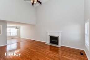 Clarksville house for rent - a living room with wood flooring and a fireplace