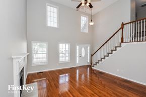 Clarksville house for rent - an empty living room with wood floors and a staircase