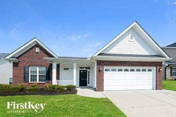 Kernersville house for rent - a home with a white garage door and a brick house